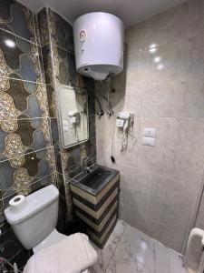 a bathroom with a toilet and a sink at Isis Pyramids View Inn in Cairo