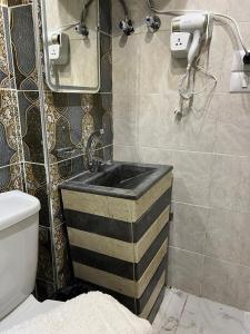 a bathroom with a sink and a toilet at Isis Pyramids View Inn in Cairo