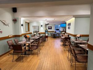 a dining room with wooden tables and chairs at The Bell and Bottle in Hedgerley