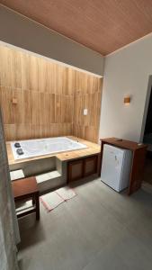 a large bathroom with a tub and a table and a refrigerator at POUSADA IRMAOS ATINS in Atins +33 photos