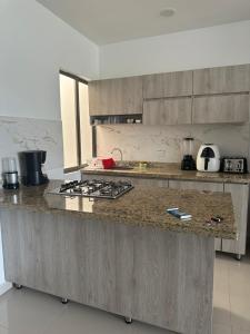 a kitchen with a counter with a stove top at Bien ubicado 3 -habitaciones 3- Aires in Montería