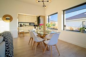 a dining room and kitchen with a table and chairs at Sunset Hills Transylvania in Odorheiu Secuiesc +28 photos