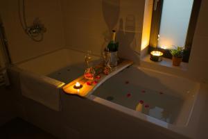 a bathroom with a bath tub with candles in it at Sunset Hills Transylvania in Odorheiu Secuiesc