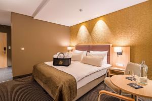 Ένα ή περισσότερα κρεβάτια σε δωμάτιο στο Best Western Premier Central Hotel Leonhard