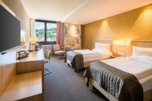 Ένα ή περισσότερα κρεβάτια σε δωμάτιο στο Best Western Premier Central Hotel Leonhard