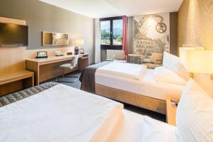 Ένα ή περισσότερα κρεβάτια σε δωμάτιο στο Best Western Premier Central Hotel Leonhard