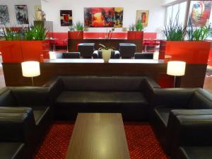 a waiting room with leather couches and a table at Best Western Plus Amedia Wien in Vienna