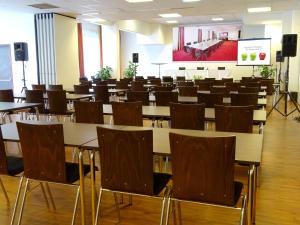 a large room with tables and chairs and a stage at Best Western Plus Amedia Wien in Vienna