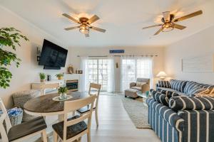 a living room with a couch and a table at 1 Mi to Maryland Beach Ocean City Retreat with Deck in Ocean City