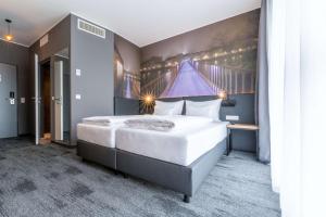 Postel nebo postele na pokoji v ubytování Aiden by Best Western Stadtgut Hotel Steyr - FREE PARKING + 37 fotografií