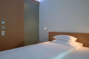 Postel nebo postele na pokoji v ubytování Best Western Hotel Spinnerei Linz