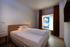 Postel nebo postele na pokoji v ubytování Best Western Hotel Spinnerei Linz