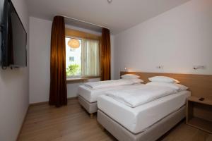 Postel nebo postele na pokoji v ubytování Best Western Hotel Spinnerei Linz