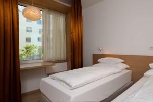 Postel nebo postele na pokoji v ubytování Best Western Hotel Spinnerei Linz