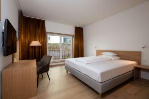 Postel nebo postele na pokoji v ubytování Best Western Hotel Spinnerei Linz