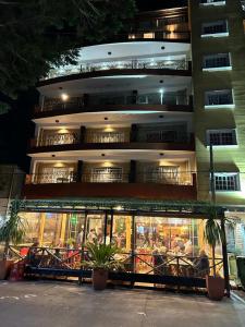 a building with a restaurant in front of it at Departamento Anthony Refugio del mar in Santa Teresita