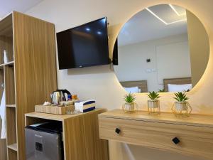 a room with a large mirror and a tv on the wall at Isis Pyramids View Inn in Cairo