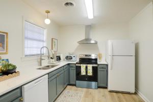 a kitchen with blue cabinets and a white refrigerator at 2 Blocks to Oxford Square Ole Miss Retreat in Oxford