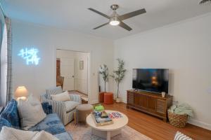 a living room with a couch and a tv at Walk to Oxford Square and Ole Miss Central Home! in Oxford