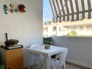 a small white table and chairs on a balcony at A Mare in Vasto