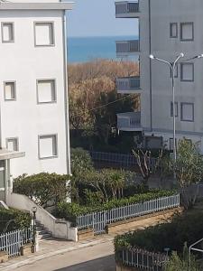 a building with a fence next to a building at A Mare in Vasto +12 photos