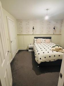 a bedroom with a bed with a black and white comforter at Beautiful 3 bed holiday home in Washington, UK in Washington