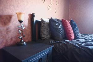a bedroom with a bed and a lamp on a dresser at Vintage Queen Suite - 7 mins From ATL Airport in Riverdale