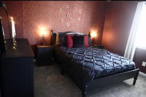 a bedroom with a bed with two night stands and two lamps at Vintage Queen Suite - 7 mins From ATL Airport in Riverdale