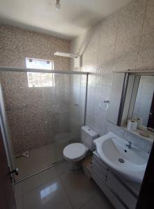 Un baño con inodoro, lavabo y ducha. en Vanessa pousada familiar, en São Gabriel 10 fotos más