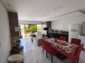 Una cocina y una sala de estar con una mesa y un sofá. en Vanessa pousada familiar, en São Gabriel