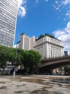 a bridge in a city with tall buildings at Metrô República SP Apartamento in Sao Paulo +38 photos