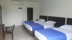 Hotel Bucare客房内的一张或多张床位