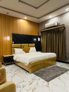 a bedroom with a large bed in a room at Tulip Hotel in Karachi +35 photos