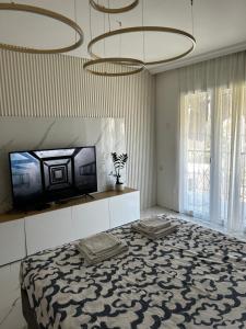a bedroom with a bed and a tv at Private luxurious house with pool for 15 people in Tivat