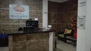 a store counter with a tree sign on a wall at Hotel Bucare in Yopal