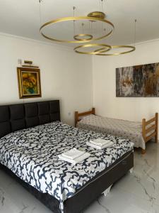 a bedroom with a bed and a chandelier at Private luxurious house with pool for 15 people in Tivat +15 photos