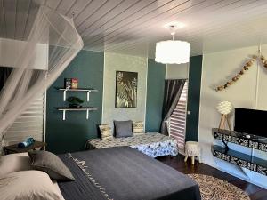 a bedroom with a bed and a tv in it at Fare Miti Ora in Hauru