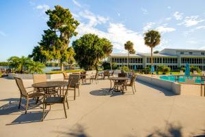a patio with tables and chairs next to a pool at River-View Condo with Boat Slip in Welaka! in Welaka