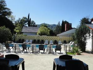 a patio with chairs and a table and a pool at Posada Ojo de Agua Villa General Belgrano in Villa General Belgrano +100 photos
