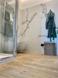 a bathroom with a shower and a toilet and a sink at Lettera Luxury Apartment in Formia