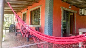 a hammock on the porch of a house at Casa en Bella Vista il fienile para 2 Personas in Bella Vista