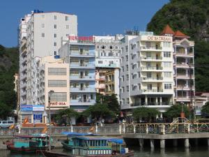 a group of tall buildings next to a river at Catba Dream Hotel in Cat Ba