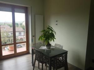 a dining room table with a potted plant on it at K2 Montalcino Apartment in Torrenieri
