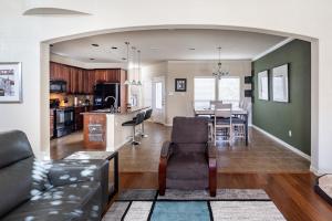 a living room and kitchen with a couch and a table at Bright and Spacious 3 Bedroom Townhome, Minutes from DFW Airport in Irving