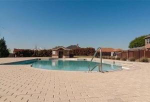 a small swimming pool with a metal hand rail at Bright and Spacious 3 Bedroom Townhome, Minutes from DFW Airport in Irving