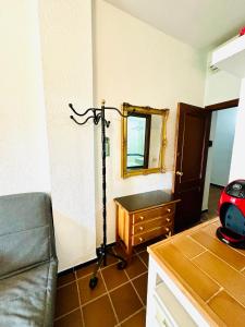 a living room with a couch and a mirror at Puente del Rey, El Rocio Deluxe in El Rocío