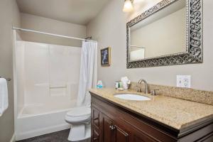 a bathroom with a sink and a toilet and a mirror at Beach Mode in Seaside +29 photos