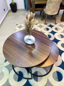a wooden table with a vase on top of it at Welcome Home202 Saint-Louis in Saint-Louis