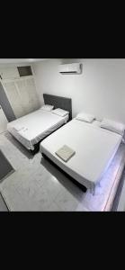 two beds sitting in a room with at Excelente vista in Cartagena de Indias