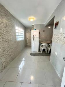 a kitchen with a refrigerator and a table at Casa azul in Maragogi +17 photos
